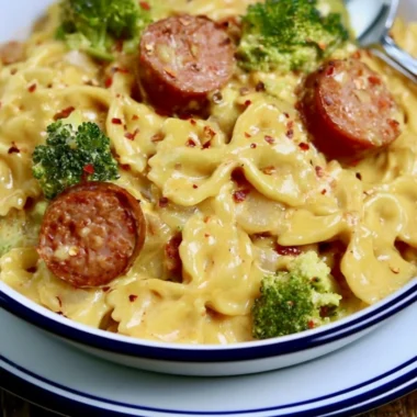 Cozy smoked sausage cheddar pasta dish, garnished and ready to serve.