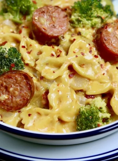 Cozy smoked sausage cheddar pasta dish, garnished and ready to serve.
