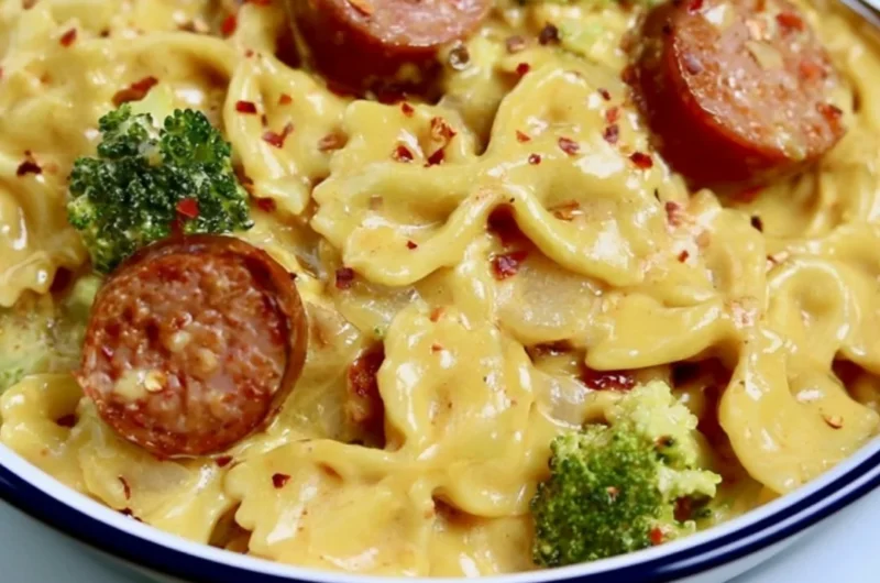 Cozy smoked sausage cheddar pasta dish, garnished and ready to serve.