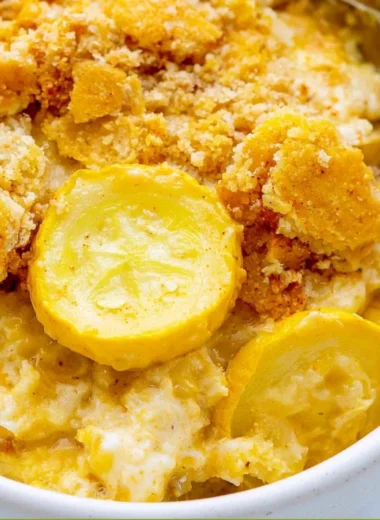 Classic Squash Casserole dish with cheesy topping and fresh squash