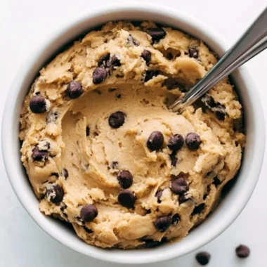 Delicious cozy edible cookie dough in a bowl, evoking sweet nostalgia.