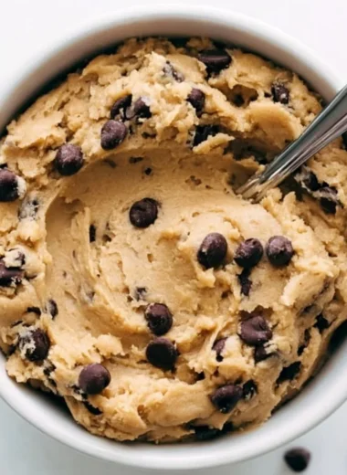Delicious cozy edible cookie dough in a bowl, evoking sweet nostalgia.