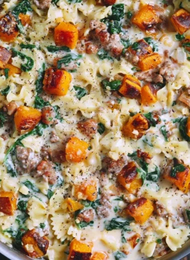 Creamy butternut squash pasta with sausage and spinach in a bowl