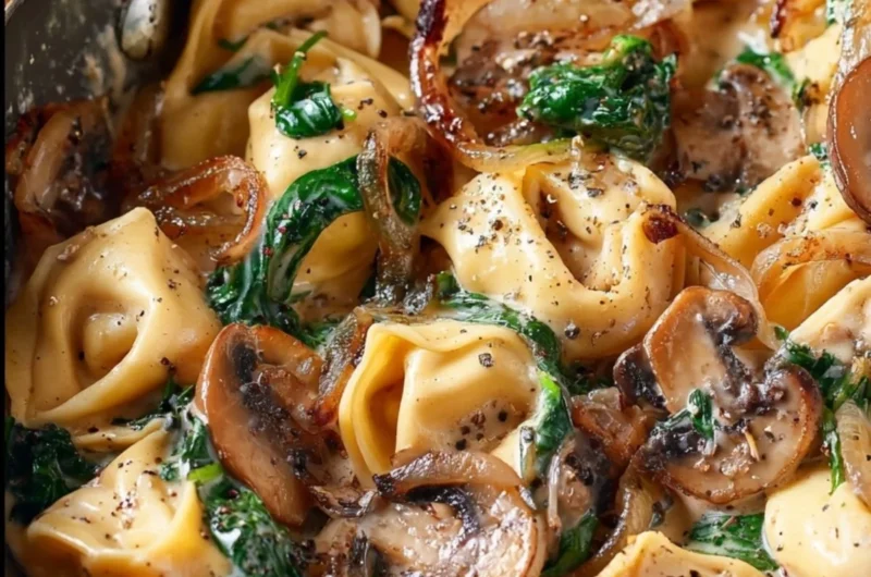 Creamy tortellini dish with spinach, mushrooms, and caramelized onions