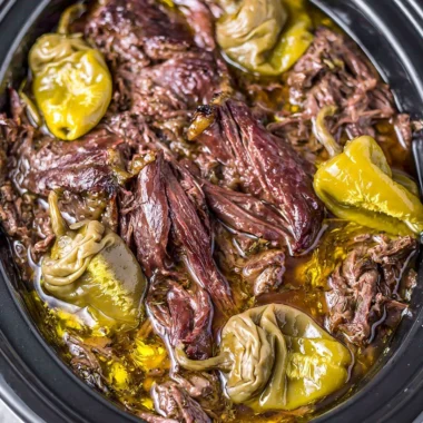 Delicious Crockpot Mississippi Pot Roast served with vegetables and herbs