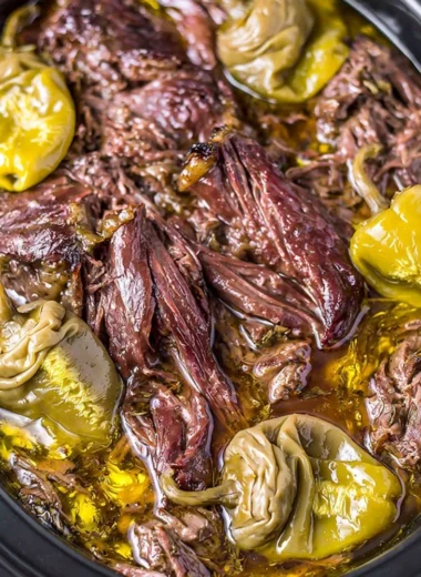 Delicious Crockpot Mississippi Pot Roast served with vegetables and herbs