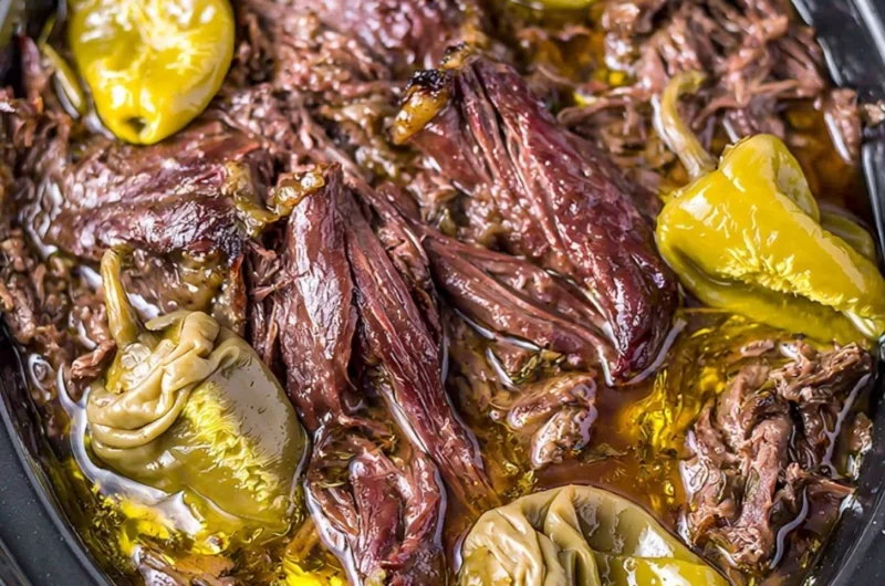 Delicious Crockpot Mississippi Pot Roast served with vegetables and herbs