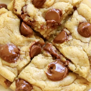 Crumbl chocolate chip cookies with melted chocolate chunks on a plate