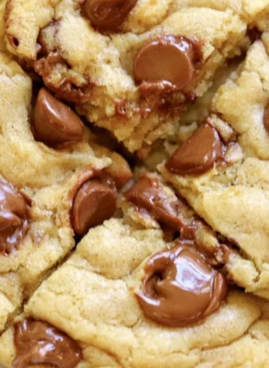 Crumbl chocolate chip cookies with melted chocolate chunks on a plate