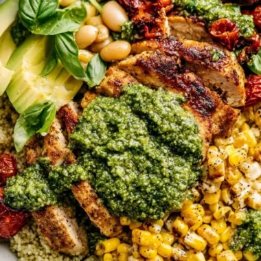 Plate of delicious pesto chicken garnished with fresh herbs