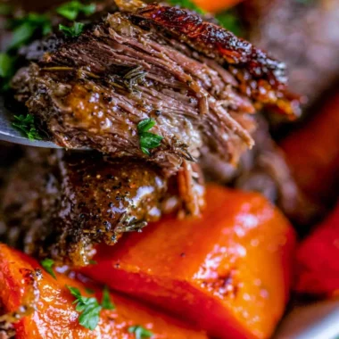 Delicious easy slow cooker pot roast with vegetables in a serving dish.