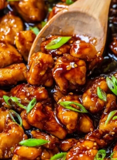 Plate of honey garlic chicken garnished with green onions