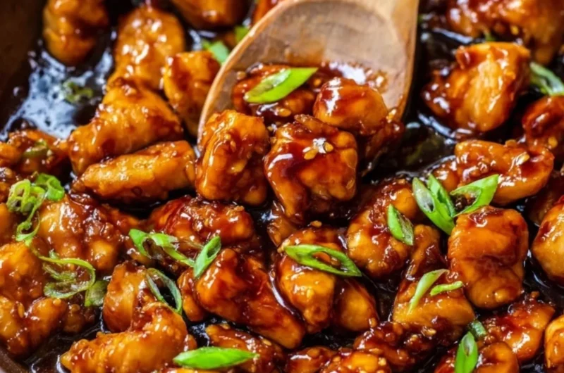 Plate of honey garlic chicken garnished with green onions