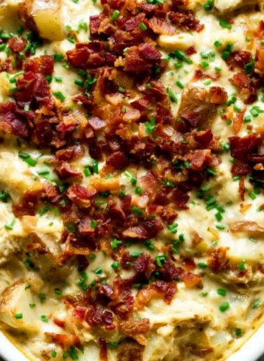 Savory Creamy Chicken Potato Casserole topped with cheese and herbs