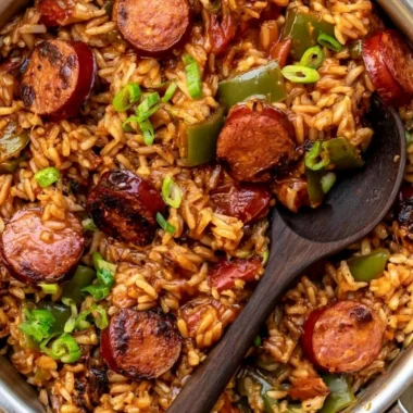 Cozy Cajun Sausage and Rice in a bowl garnished with herbs