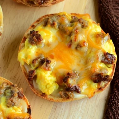 Cozy English muffin breakfast pizza topped with eggs and cheese