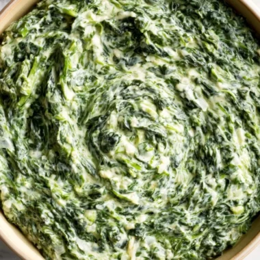A delicious dish of creamy and comforting creamed spinach served as a side.