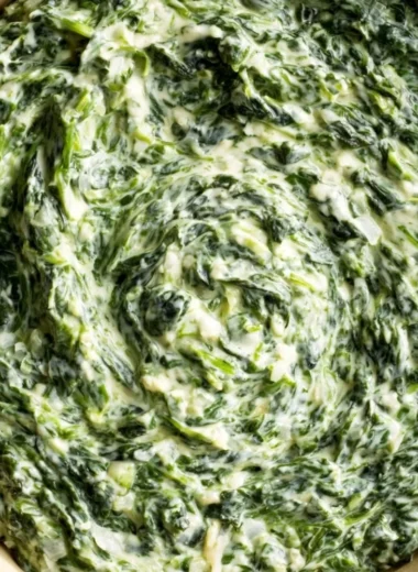 A delicious dish of creamy and comforting creamed spinach served as a side.