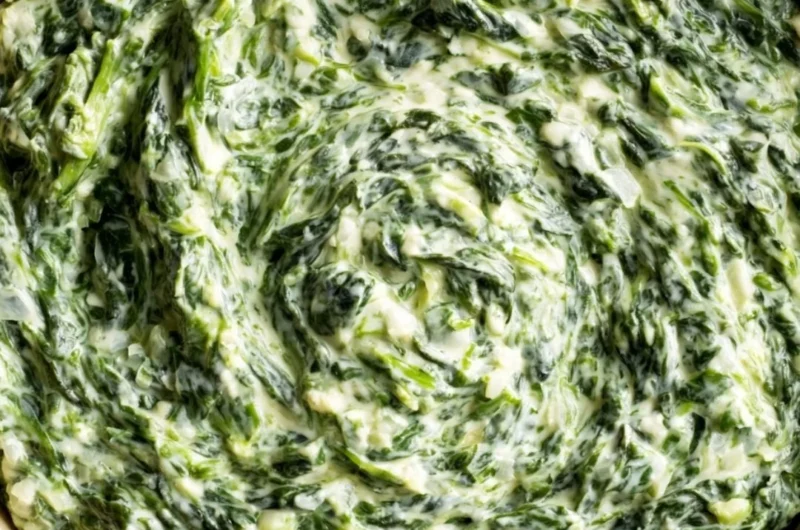 A delicious dish of creamy and comforting creamed spinach served as a side.