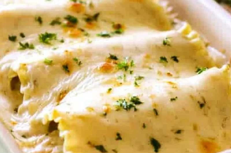 Creamy Chicken Alfredo Roll Ups served on a plate, topped with parsley.