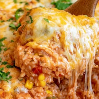 Easy One Pot Cheesy Enchilada Rice dish garnished with fresh herbs