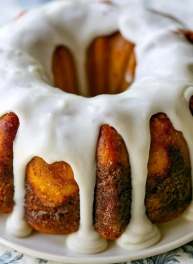 Homemade cinnamon roll bundt cake topped with icing on a plate