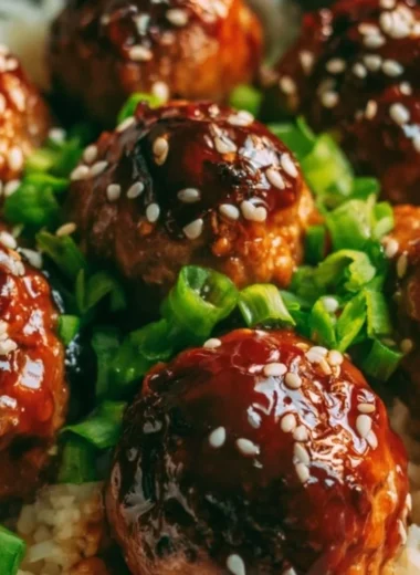 Delicious Asian Meatballs served with sauce and green onions.