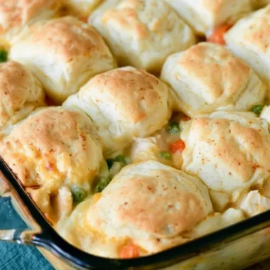 Cozy chicken pot pie with flaky biscuits on a rustic table