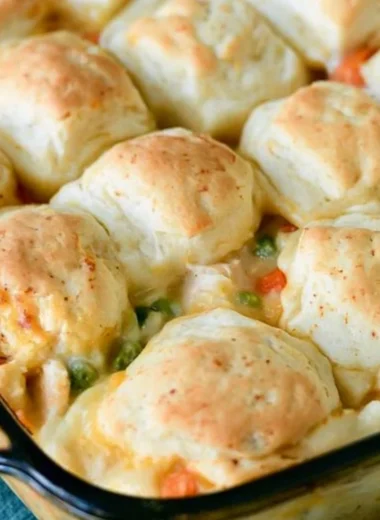 Cozy chicken pot pie with flaky biscuits on a rustic table