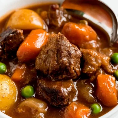 Cozy slow cooker beef stew in a bowl with fresh herbs on top