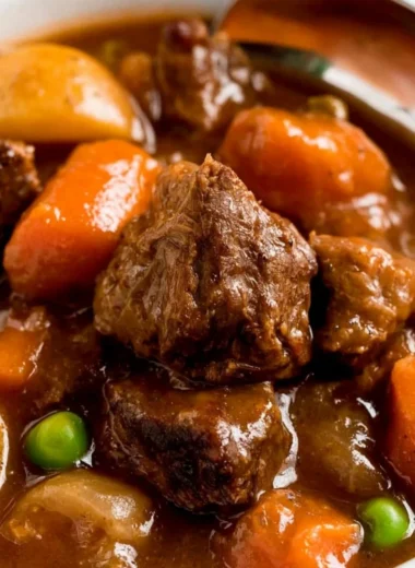 Cozy slow cooker beef stew in a bowl with fresh herbs on top