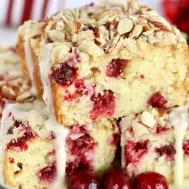 Homemade Cranberry Almond Cake decorated with fresh cranberries and almonds.