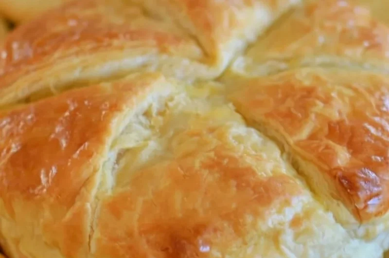 Delicious baked brie wrapped in flaky puff pastry, served as an elegant appetizer.
