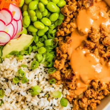 Delicious Bang Bang Ground Turkey Rice Bowls garnished with fresh vegetables