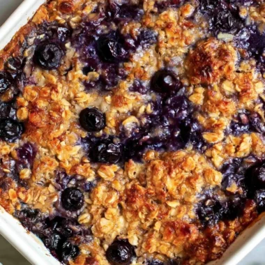 Delicious blueberry baked oatmeal dish topped with fresh blueberries