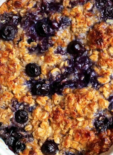 Delicious blueberry baked oatmeal dish topped with fresh blueberries