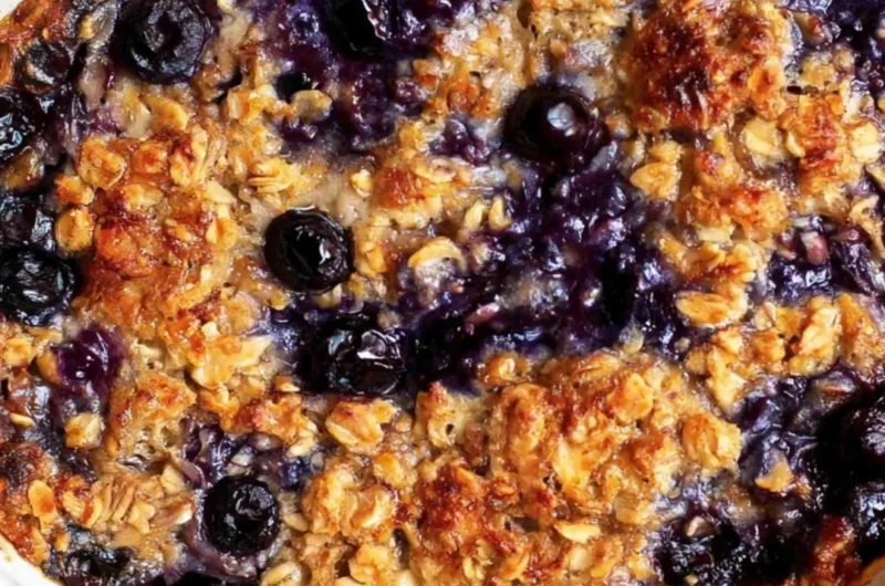Delicious blueberry baked oatmeal dish topped with fresh blueberries