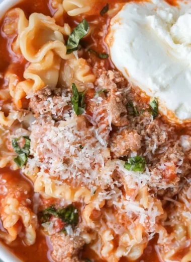Bowl of healthy lasagna soup garnished with herbs and cheese