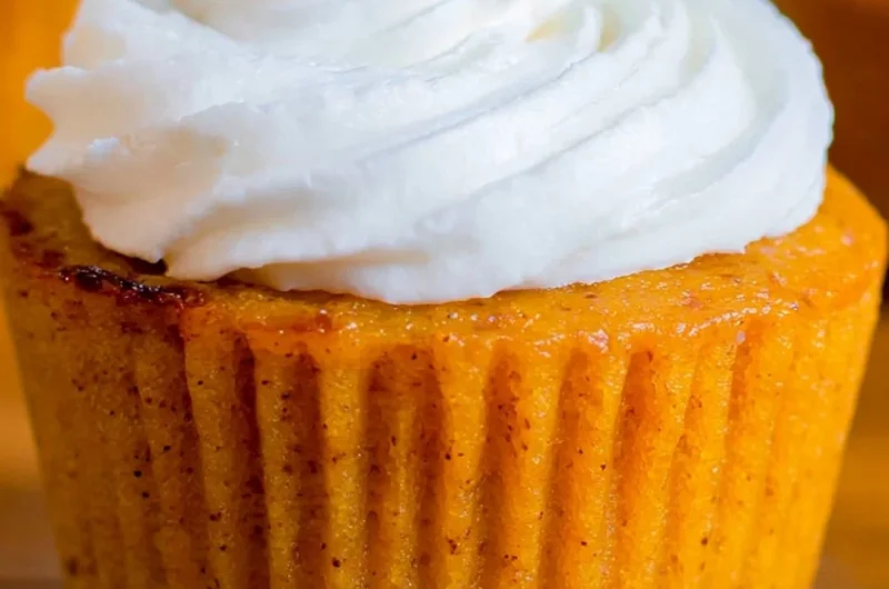 Delicious Impossible Pumpkin Pie Cupcakes topped with cream cheese frosting.