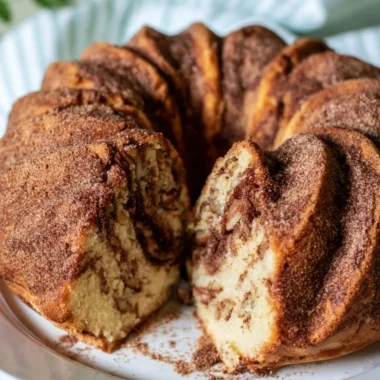 Deliciously moist Cinnamon Coffee Cake topped with a cinnamon crumble.