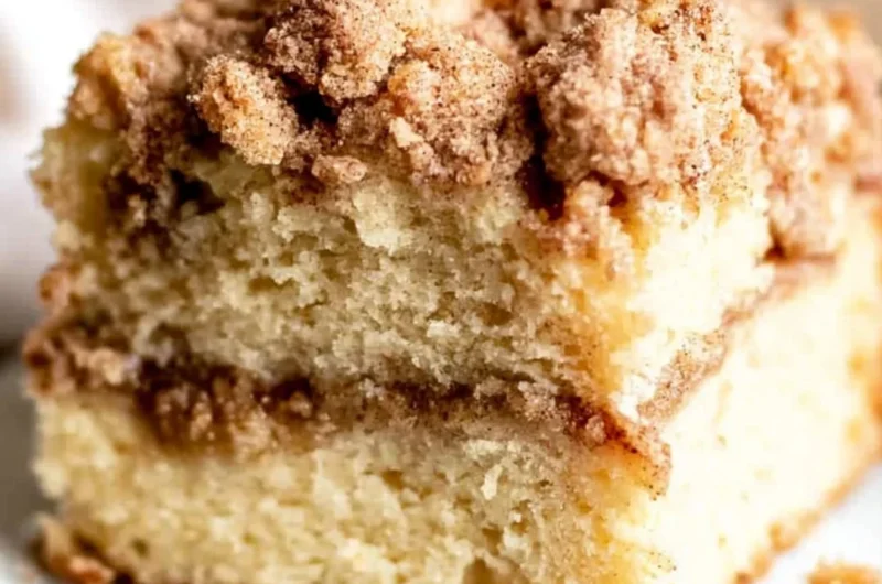 Sour cream coffee cake with cinnamon topping on a serving plate