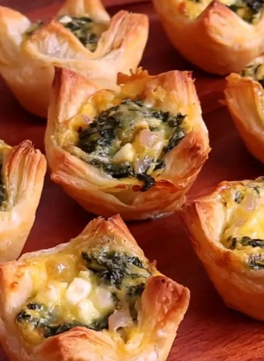 Freshly baked spinach puffs on a serving platter