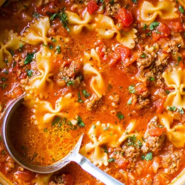 A hearty bowl of the world's best lasagna soup with melted cheese and herbs.