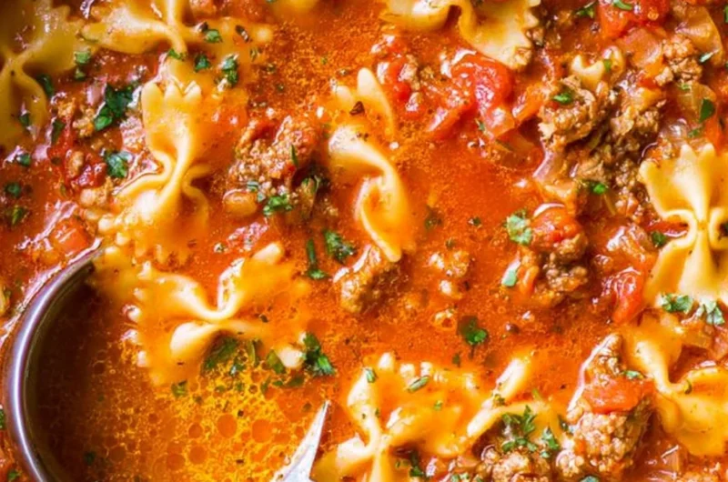 A hearty bowl of the world's best lasagna soup with melted cheese and herbs.